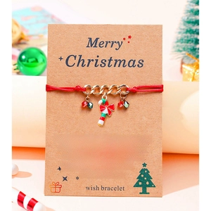 Close-up of a Christmas candy cane charm bracelet on a festive wish card background