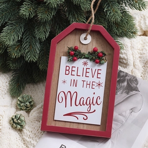 Christmas wooden door hanging sign with Believe in the Magic text and pine cone decor