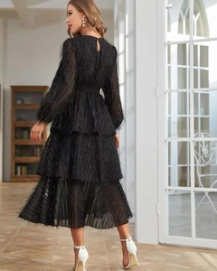 Detail of tiered black feather texture dress with back cutout and button closure