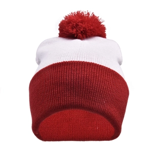 Close-up of red and white knit Christmas beanie with fluffy top pompom detail