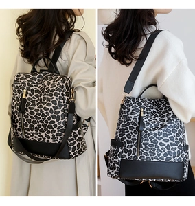 Detail of leopard print backpacks in brown and white variants with side pockets