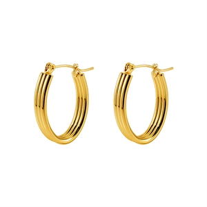 Macro shot of gold multi-layer triple hoop earrings with a polished mirror finish