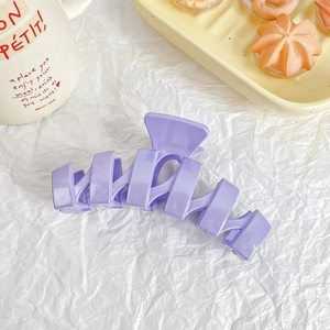 Detailed view of large lavender glitter hair claw clip with wavy geometric structure