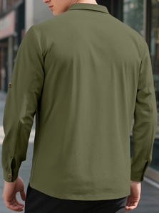 Detail view of olive green linen shirt fabric texture and back seam tailoring