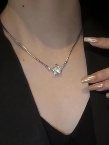 Macro shot of silver magnetic star necklace featuring sparkling inlaid rhinestones