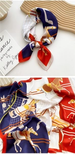 Detail of navy and orange equestrian pattern silk scarf with horses and bridles print