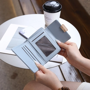 Light blue PU leather wallet detail showing card slots and a clear ID window