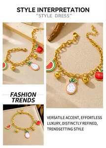 Detail of gold fruit charm bracelet with dragon fruit and watermelon drop oil pendants