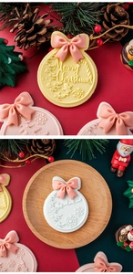 Detail of Christmas fondant cookies with pink bows and festive embossed patterns