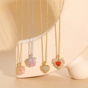 Pink heart gemstone and stone pendant necklaces on geometric display stands