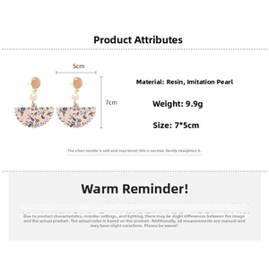 Detail view of fan-shaped resin floral earrings with pearls and 925 silver needle