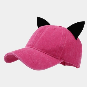 Detail of a dark pink washed canvas baseball cap featuring 3D black cat ear decorations