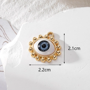 Detailed view of evil eye pendant with measurements 2.1cm height and 2.2cm width