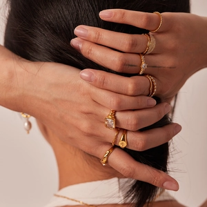 French style 18K gold plated titanium ring set with zircons shown on model hands