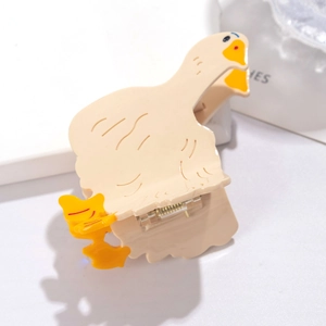 Detail view of a cute yellow duck hair claw clip with orange beak and spring mechanism