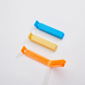 Detailed view of plastic sealing clips in blue, yellow, and orange for food storage