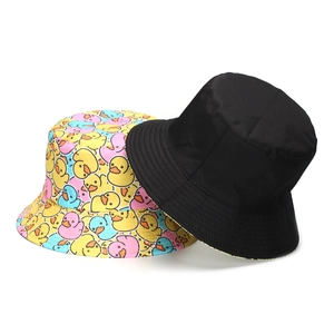 Reversible bucket hat featuring a minimalist black side and vibrant cartoon duck prints
