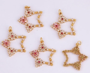 Detailed macro view of star-shaped floral pendant with colorful zircons and golden base