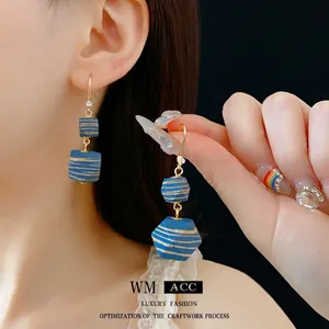 Bohemian geometric wooden bead earrings with navy blue stripes and gold hook