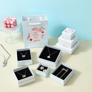 Luxury marble pattern jewelry box set with pink floral paper bags and black velvet lining