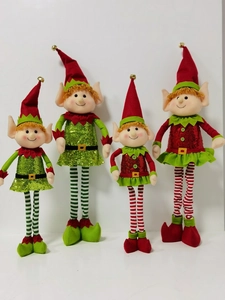 Macro detail of Christmas elf dolls showing striped long legs and sequined fabric textures