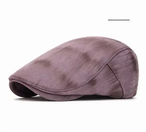 Detailed view of purple newsboy cap featuring artistic tie-dye gradient and thick fabric
