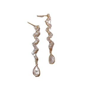 Elegant gold wavy drop earrings with white zircon accents and pear-shaped crystals