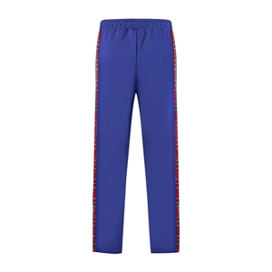 Detail view of navy blue trousers with red and green tartan side stripe panel