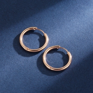 Detailed close-up of rose gold stainless steel hoop earrings with polished finish