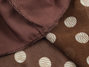 Macro view of brown polka dot fabric texture with precise stitching and inner lining detail