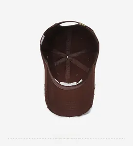 Detail view of the inner lining and adjustable metal buckle on a distressed cotton cap