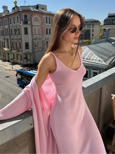 Detail of pink knitted two-piece set featuring a slip dress and matching long sleeve cardigan