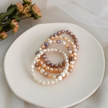 Close-up of elegant multicolor natural freshwater pearl bracelets on a ceramic tray