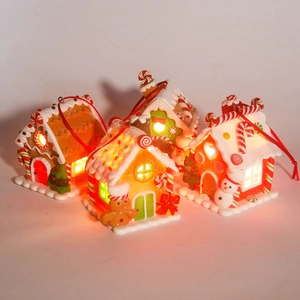 Close-up of four gingerbread house ornaments with glowing LED lights and festive details