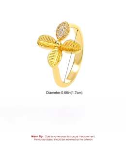 Close-up of golden leaf ring detailing copper material specs and zircon stone texture
