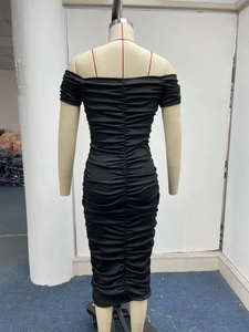 Detail view of the elegant black ruched bodycon maxi dress with pleated texture