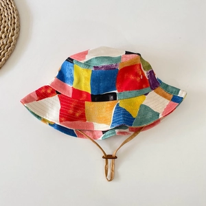 Detailed top view of a colorful geometric pattern cotton bucket hat with adjustable cord