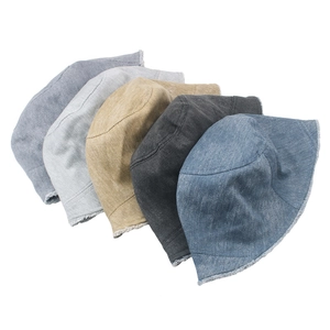 Detail of five colors of washed denim bucket hats with frayed edges on white background