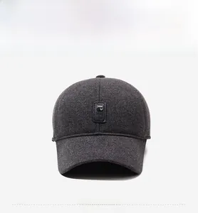 Close-up of dark grey baseball cap showing textured fabric and square leather logo patch