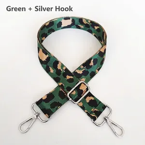 Close-up of green leopard jacquard nylon bag strap with silver metal swivel hooks