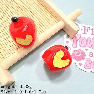 Macro detail of red resin apple charms showing 1.9x1.6cm size and 3.82g weight