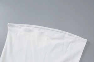 Close-up of white strapless dress featuring premium elastic fabric and fine double stitching