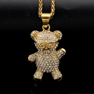 Macro shot of hiphop teddy bear pendant with sparkling rhinestones on black background