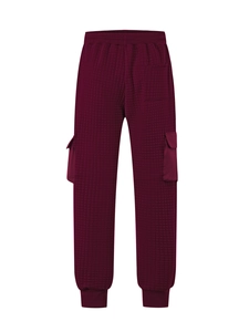 Detailed view of dark burgundy quilted cargo pants with side flap pocket and elastic cuffs