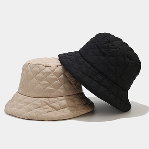 Padded quilted bucket hat with diamond lattice pattern in black and beige colors