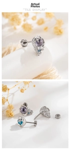 Macro shot of silver screw-back cartilage earrings with blue and purple gemstones