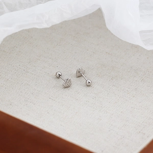 Macro shot of silver heart studs with textured finish and secure screw back closure