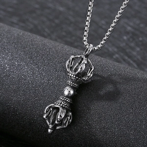Titanium steel vajra pestle pendant with box chain on a textured dark pedestal