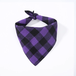 Close-up of purple and black plaid cotton dog bandana with a knot on white background