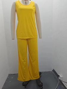 Detail view of yellow summer two-piece set featuring a ribbed tank top and wide-leg pants